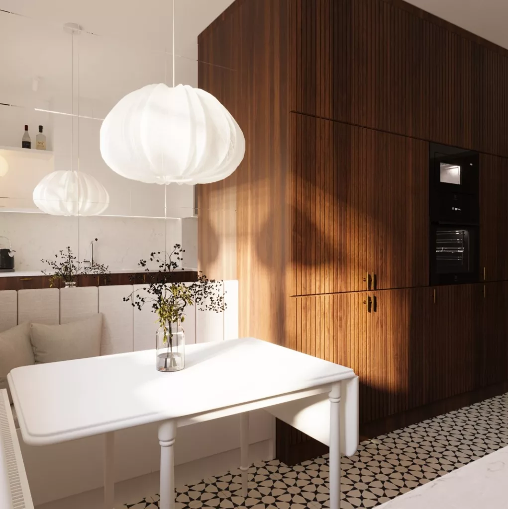 kuchnia_z_drewnem Na wizualizacji jest kuchnia. Na pierwszym planie jest biały składny stół, a na nim wazon z kwiatami. Nad stołem wisi biała puchata lampa. Ściany są biało. Przy stole zamiast krzeseł jest miękka, biała sofa. A nad nią wisi lustro. Obok stoi drewniana zabudowa z szafkami. Na podłodze są biało-czarne kafelki.