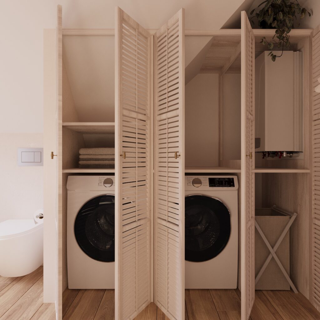 łazienka 1d Na zdjęciu jest wizualizacja łazienki. Po lewej stronie jest fragment miski ustępowej. Na pierwszym planie jest otwarta zabudowa w której znajdują się półki, wieszaki, pralka i suszarka. Pomieszczenie jest jasne. Na podłodze są panele.