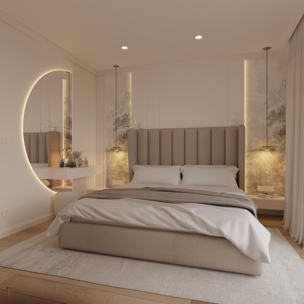 sypialnia 1a Całe zdjęcie zajmuje eleganckie łóżko, z brązowym zagłówkiem. Po jego bokach wiszą nad szafkami nocnymi długie lampy. Po lewej stronie wisi ogromne podświetlane lustro. Na podłodze leży biały dywan. Wnętrze jest bardzo eleganckie i jasne.