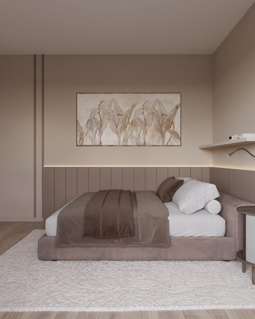 sypialnia 4c Na zdjęciu jest sypialnia, w którym dominują kolory: beż i brąz. Podłoga jest drewniana. Na pierwszym planie stoi łóżko, a nad nim wisi obraz. Pod łóżkiem leży puchaty, kremowy dywan. Po prawej stronie zdjęcia jest fragment szafki nocnej. Nad łóżkiem wisi półka i mała lampka.